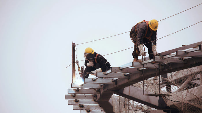 Fall protection system showing anchor point, full-body harness and connector for working at height.