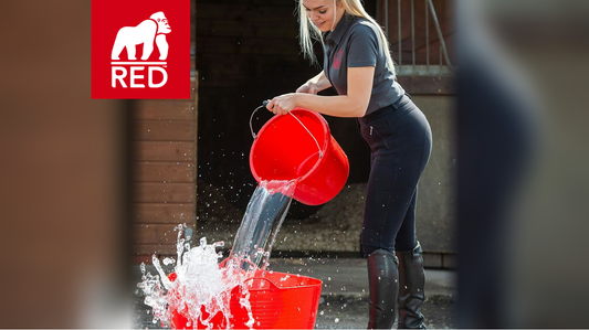 Red Gorilla heavy-duty bucket and flexible tub being used for water carrying and outdoor work.