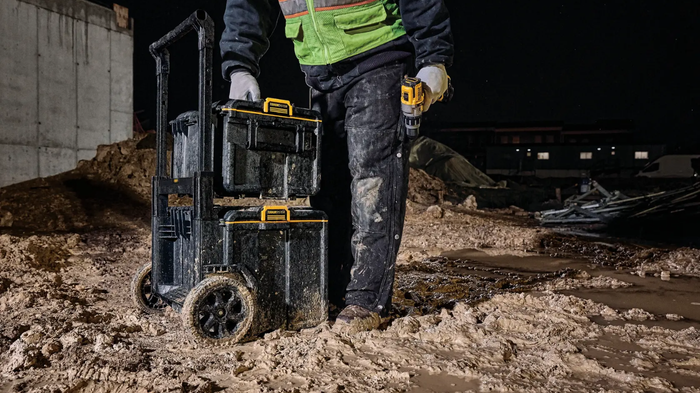 Tradesperson using a DEWALT TOUGHSYSTEM modular tool storage unit on a construction site
