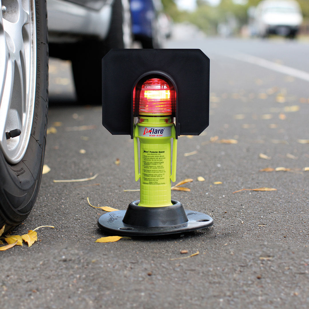 Safety stand with red light on a road next to a car tire - imagen 5