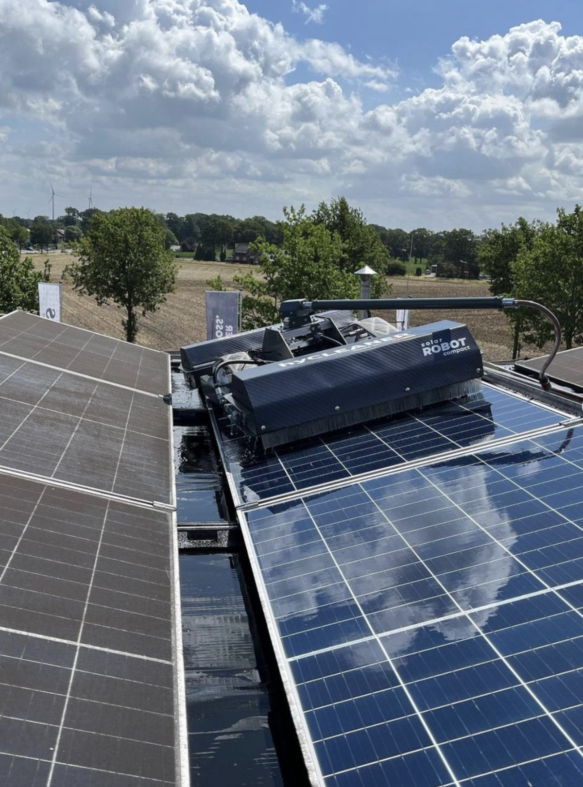 Solar panels on a roof with a clear sky and trees in the background - imagen 2
