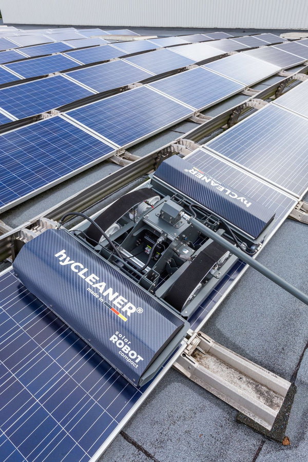 Solar panel cleaning robot on a rooftop with solar panels