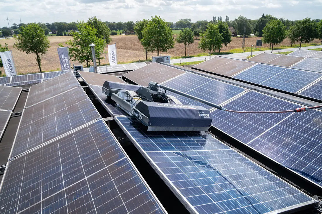 Solar panels on a roof with a tractor in the foreground, surrounded by trees and open fields. - imagen 10