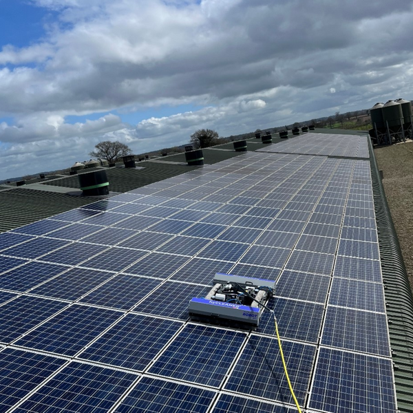 Solar panels on a roof with a cloudy sky in the background