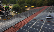 Solar panels installed on a roof with workers in the background. - imagen 9