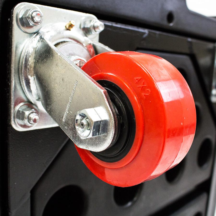 Close-up of a red wheel with metal axle on a blurred background  - imagen 6